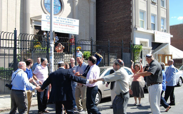 Rabbi Simon Rosenbach leads congregants in dancing outside Ahavas Sholom in Newark to welcome the arrival of the Torah scroll donated by members of Temple Beth Ahm Yisrael in Springfield. Photos by Elaine Durbach