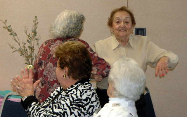 Lauran Newell, rear left, and Rose Handler dance to the music of Odessa Klezmer, watched by Helen Forman, front left, and Florence Hagman at a brunch held as part of the JCC’s ongoing adult enrichment program. Photo courtesy JCC of Central NJ