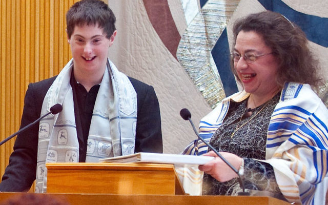 Special education teacher Debbie Linder helped Sam Frankel, who has Down’s Syndrome, read from the Torah at his bar mitzva ceremony.
