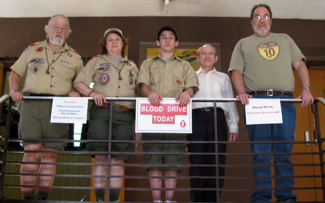 Micah Lubow, center, observes the Eagle Scout project/Mitzva Day activities he organized at Temple Beth-El Mekor Chayim, with, from left, Troop 118 scoutmaster Mike Schatzberg; assistant scoutmaster Rabbi Lisa Vernon; Micah’s father, Rabbi Akiba L
