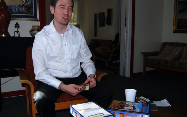 Chaim Kivelevitz demonstrates the card game he and his partners created, “Cholent, The Game!”