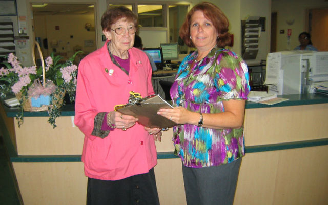 Lisa Liss, right, coordinates the work of volunteers like Roz Schwartzberg, who support the staff at Trinitas Regional Medical Center in meeting patients’ needs.