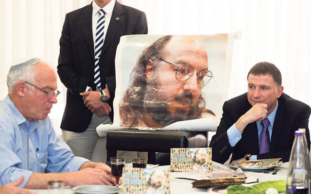 Uri Ariel, left, Israel’s minister of housing, and Knesset chair Yuli Edelstein at a Passover seder held in honor of Jonathan Pollard, pictured, at the Knesset, April 8, 2014. 