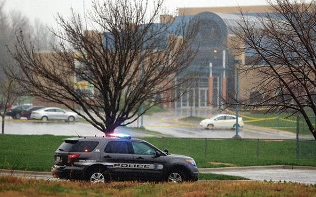 An Overland Park police vehicle in front of the JCC of Greater Kansas City, Kan., following shootings there and later at a nearby assisted-living complex that killed three people, April 13.     