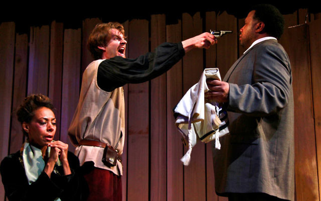 From Under the Cross at the New World Theatre Project: Convert Moshke Ferapontov (Stephen Marcus Naylor, right) is attacked by Russian peasant Akim (Dan Beilinski) for harboring Rohkl Leye (Trish McCall, seated), a Jewish woman who was raped duri