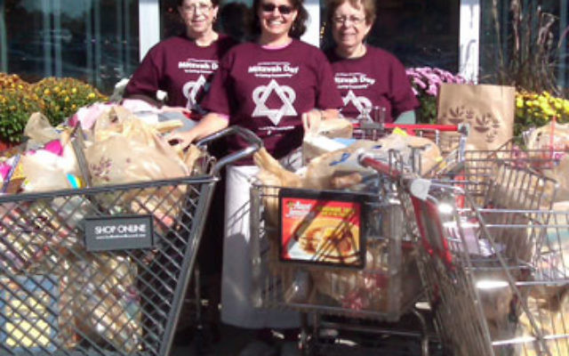 On Mitzvah Day, members of the Young Israel of Aberdeen sisterhood, from left, Thea Byock, Emily Edelstein, and sisterhood president Eleanor Edelstein collected 13 carts of nonperishable items from shoppers at Stop & Shop in Aberdeen to contribute to