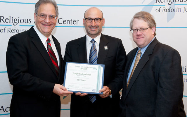 Rabbi Donald Weber of Temple Rodeph Torah, left, and David Levy, TRT CARES chair, center, receive the Fain Award from Mark Pelavin, associate director of the Religious Action Center for Reform Judaism, at the Consultation on Conscience in Washington, DC.