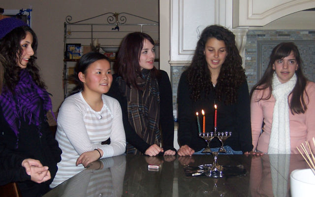 Celebrating the second night of Hanukka during the Israeli teens’ visit to Monmouth County are, from left, Neria Aber, teen host Jade Saybolt, Michal Weisman, Chen Avraham, and Nitzan Rubin.