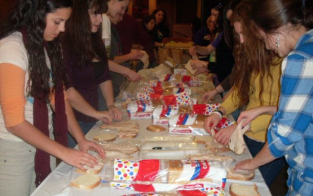 Teens from Temple Beth Miriam youth group assemble sandwiches the evening of Jan. 23 before their Midnight Run to Manhattan to distribute food, clothing, and toiletries to the homeless.