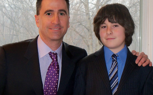 Roland Muller and his son, Jeremy, after their joint bar mitzva service.