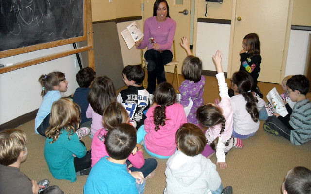 Alexis Gruber, the JCC’s Jewish educator for children and families, teaches children about the Torah at a class in October 2010. Photo courtesy JCC MetroWest
