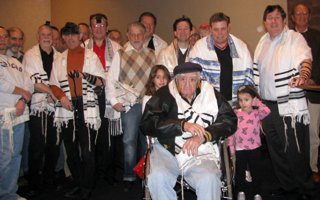 Temple B’nai Abraham men’s club members gather after Sunday morning minyan to salute 101-year-old Jack Oelbaum.