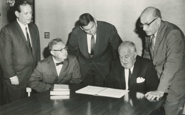Merger documents to establish the Jewish Counseling Service Agency, a predecessor of Jewish Family Service of MetroWest, were signed and witnessed by, from left, Irving Greenberg, Martin Jelin, Abner Benisch, Herbert Hannoch, and Herman Pekarsky in 1961