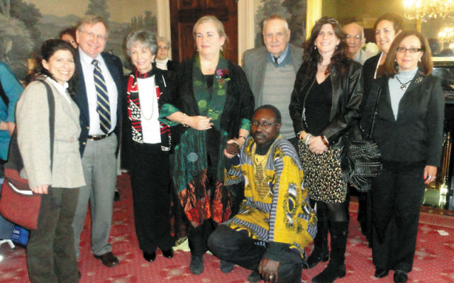 Joyce Reilly, co-convenor of NJ Coalition Responds to the Crisis in Darfur, fourth from left, was honored April 3 at Drew University’s Center for Holocaust/Genocide Study; with her are Darfurian national Hisham Osman, front, and, from left, Tobi Ind