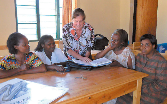Helen Jacobson with genocide widows in Rwanda last July; Jewish Helping Hands provides skills training for the women so they can support themselves. Photos courtesy Helen Jacobson