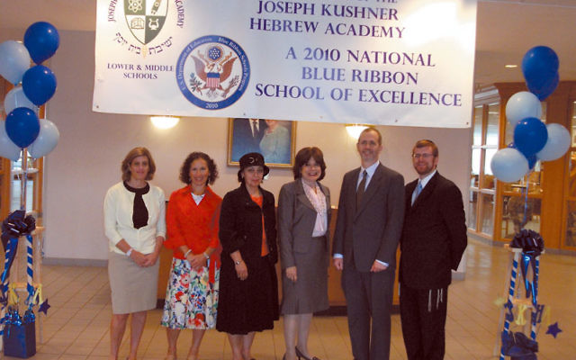 Administrators at the Joseph Kushner Hebrew Academy, standing under their banner proclaiming their Blue Ribbon School status, are, from left, Debbie Finkelstein, middle school associate principal; Shari Faleck, lower school director of student services;