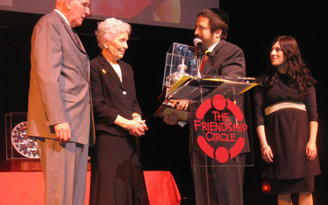 Jerry and Paula Gottesman, left, receive a Keter Torah award from Rabbi Zalman and Toba Grossbaum, directors of the Friendship Circle. Photo by Johanna Ginsberg