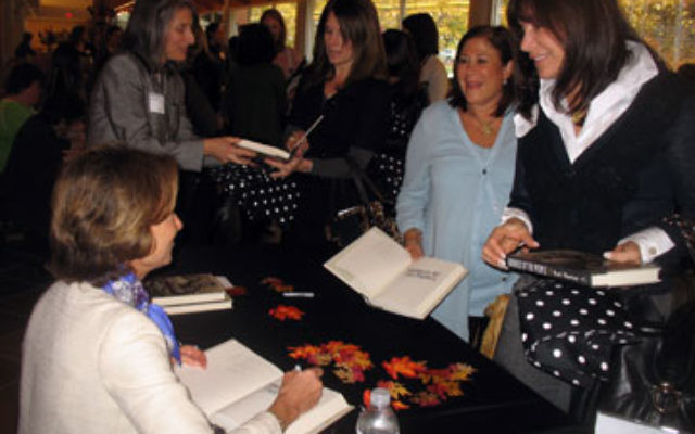 Kati Marton, left, signs books after the event.