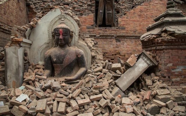 A statue of the Buddha surrounded by debris from a collapsed temple in Bhaktapur, Nepal, April 26, 2015. (Omar Havana/Getty Images)