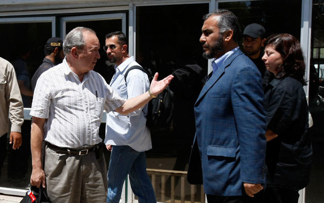 Richard Goldstone, left, shown meeting on June 1, 2009, with Ghazi Hamad of Hamas at the Rafah border crossing with Egypt, now says his report’s finding that Israel intentionally targeted civilians in the Gaza war was mistaken. Photo by Rahim Khatib
