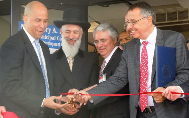 At the June 14 ribbon-cutting ceremony to unveil Manischewitz's new corporate headquarters in Newark are, from left, Mayor Cory Booker, Rabbi Yona Metzger, Alain Bankier, and Paul Bensabat. Photo by Susan Bloom