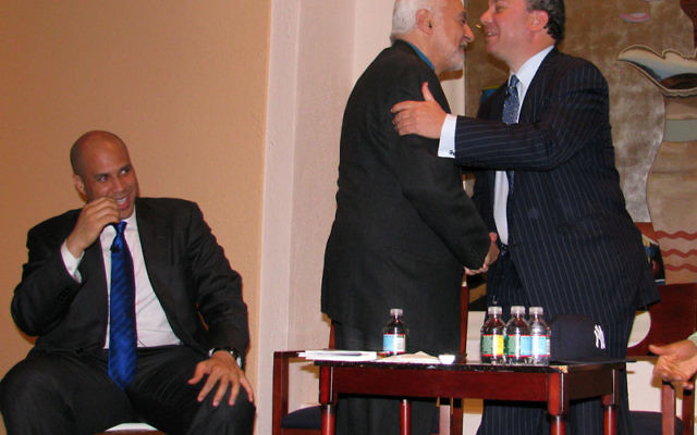 Rabbi Marc Schneier, right, greets Imam Feisal Abdul Rauf at “a conversation on the Black/Jewish Alliance” in the Newark Museum. Mayor Cory Booker, left, looks on. Photos by Robert Wiener