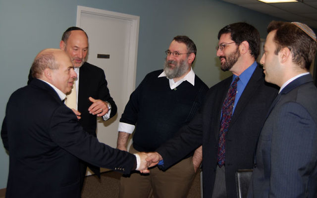 At a breakfast meeting hosted this week by the Central federation, Jewish Agency chair Natan Sharansky, with federation executive vice president Stanley Stone, second from left, greets, from left, Rabbi George Nudell, Rabbi Joel Abraham, and Rabbi Ben G