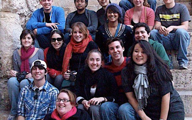 Project Interchange students sit on the steps outside the Church of the Holy Sepulcher in Jerusalem. Brian Solomon, smiling, is seated on the far right of the third row from the bottom. Brian No, wearing glasses, is seated on the left of the next to last