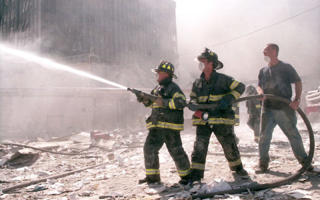 New York City firefighters work near Ground Zero after the collapse of the Twin Towers on Sept. 11. Photo by Anthony Correia/Shutterstock