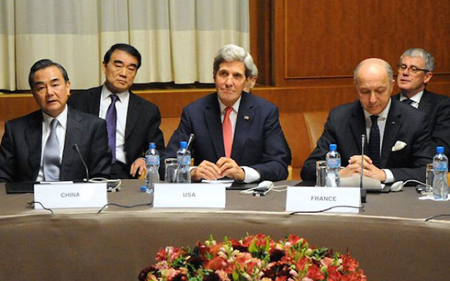 U.S. Secretary of State John Kerry sitting between Chinese Foreign Minister Wang Yi and French Foreign Minister Laurent Fabius at U.N. headquarters in Geneva after world powers concluded a nuclear deal with Iran, Nov. 24, 2013. (Wikimedia Commons)