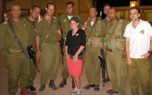 Peri Feldstein poses with Israeli soldiers at Gush Etzion after delivering treats and letters from her classmates in Princeton.