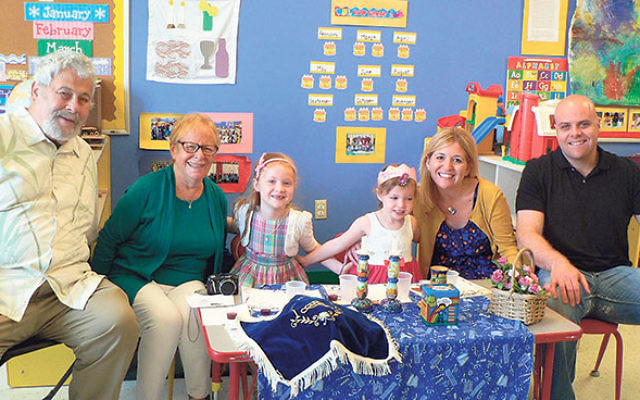 A “Shabbat girl” celebrates with her family at the Early Childhood Center of Congregation Agudath Israel in Caldwell, which is adding a class for toddlers this fall. 