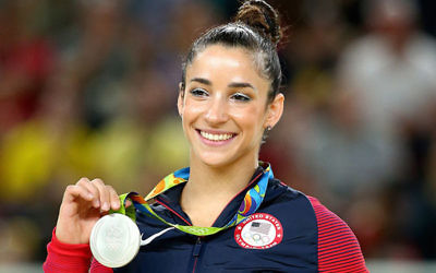 Aly Raisman celebrates on the podium after winning a silver medal in the floor exercise at the Rio Olympic Arena, Aug. 16, 2016. (Alex Livesey/Getty Images)