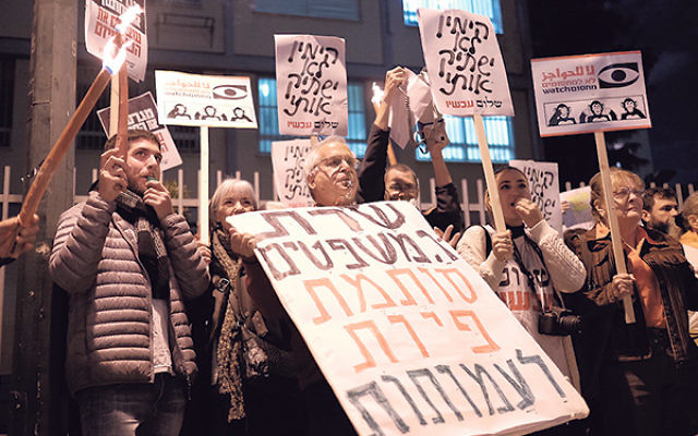 Activists protesting a proposed law governing NGO financial disclosure outside the Tel Aviv home of Israeli Justice Minister Ayelet Shaked, Dec. 26, 2015.      