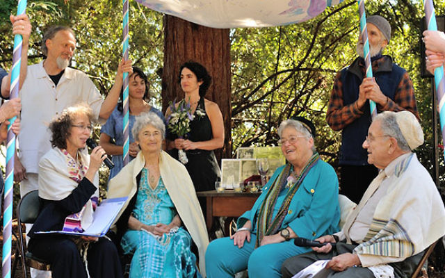 At 76, longtime activists Shoshana Dembitz, seated, center left, and Abigail Grafton, seated, center right, married in El Cerrito, Calif., on June 27. The ceremony was officiated by Rabbi Diane Elliot, seated left, and her husband, Rabbi Burt Jacobson. (L