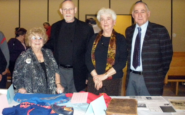 With Rabbi Eugene Wernick, second from left, three survivors — from left, Vera Nussenbaum and Ruth and Dr. Eugene Gottlieb — commemorate Kristillnacht at Congregation Beth Ohr in Old Bridge on Nov. 9. The display of items includes the dress