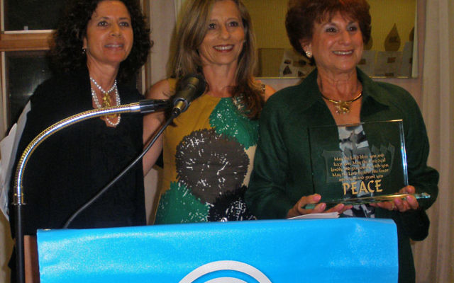 Susan Mandell, right, receives the Kipnis-Wilson/Friedland Award-National Women’s Philanthropy during the Middlesex federation’s annual meeting, as federation president Arlene Frumkin, left, and vice president Sandy Lenger look on. Photo by De