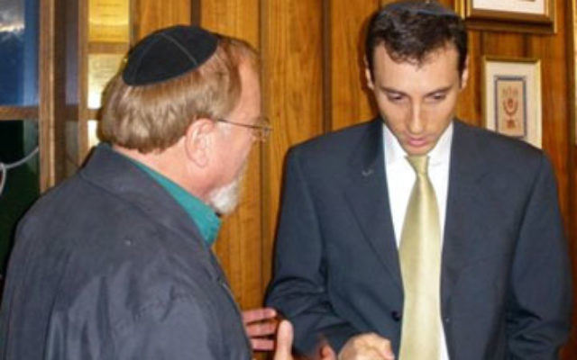 Uriel Heilman, right, managing editor of the Jewish Telegraphic Agency, speaks to a congregant at Temple Beth El of Somerset after delivering the annual Dr. Michael Fink Memorial Lecture.