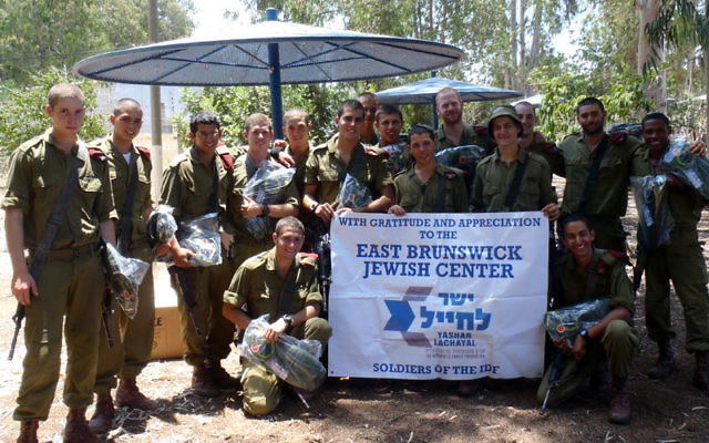 Members of an IDF paratrooper unit thank the East Brunswick Jewish Center for a donation of water backpacks last month through Yashar LaChayal, which assists poor and “lone” soldiers.