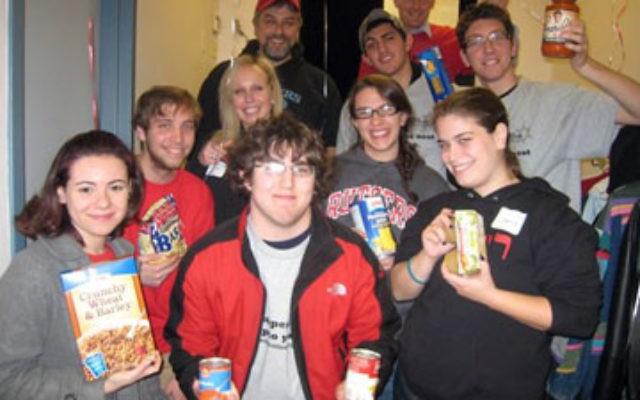 Students and staff from Rutgers Hillel, a beneficiary of Jewish Federation of Greater Middlesex County, arriving at Super Sunday to make phone calls, accompanied by Hillel executive director Andrew Getraer, rear left, and Rabbi Yisroel Porath, rear right,