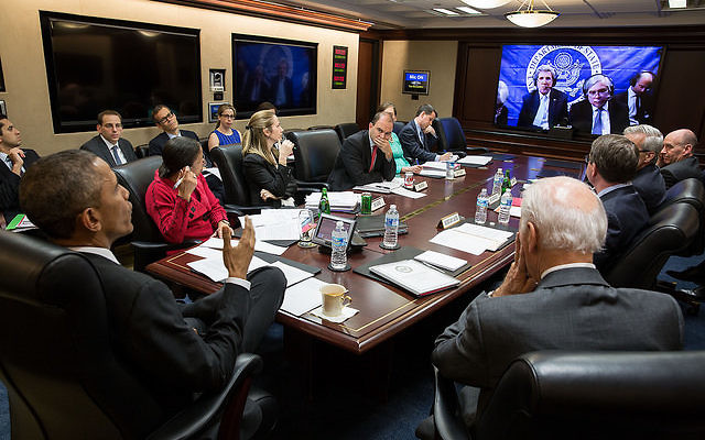 President Barack Obama and Vice President Joe Biden, with members of the national security team, participate in a secure video teleconference from the Situation Room of the White House with Secretary of State John Kerry, Secretary of Energy Ernest Moniz,