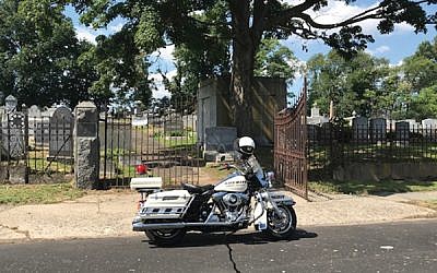 A police motorcycle outside the B’nai Abraham cemetery on Sunday. Courtesy Federation