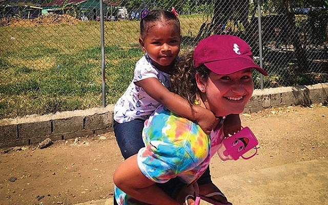 Alina Keller gives a piggyback ride to a Dominican child. Photos courtesy Alina Keller