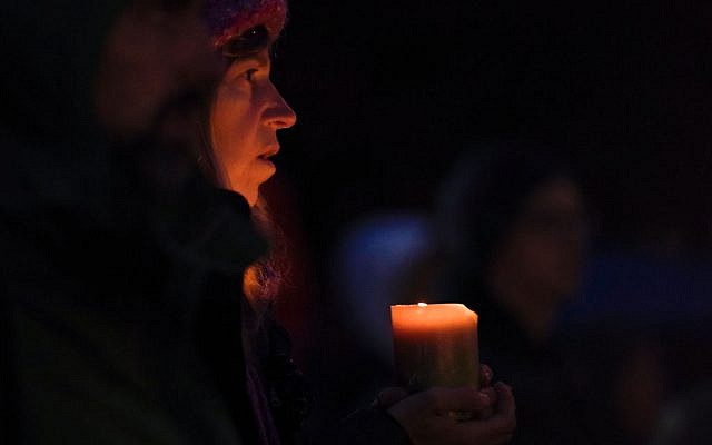 A woman holds a candle during a vigil in Squirrel Hill, Pennsylvania on October 27, 2018, to remember those that died in the Tree of Life Synagogue shooting earlier in the day. Getty Images