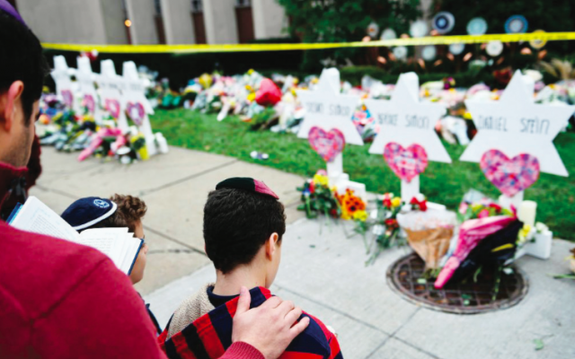 Praying at a memorial outside of the synagogue in Pittsburgh where 11 congregants were murdered. Brendan Smialowski/AFP/Getty Images