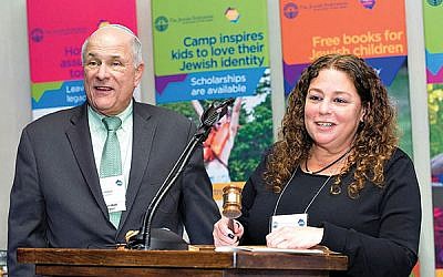 Outgoing federation president Jeffrey Schwartz turns the reins over to his successor, Cheryl Markbreiter. Photos courtesy The Jewish Federation in the Heart of NJ