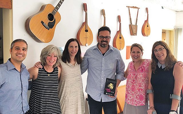 Ohn Cohen, director of the Arad Music Conservatory, left, and Arad Mayor Nisan Ben-Hamo give Women’s Philanthropy professionals a tour of the facility in October.