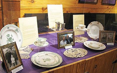 Display case with dishes owned by Lola Kline, whose Holocaust survivor parents brought them to the United States; Kiddush cups passed down for five generations in the Helfand family; and the Limoges china given to Alice Berman’s grandparents for their 1902 wedding. (Photo courtesy Jewish Heritage Museum of Monmouth County)