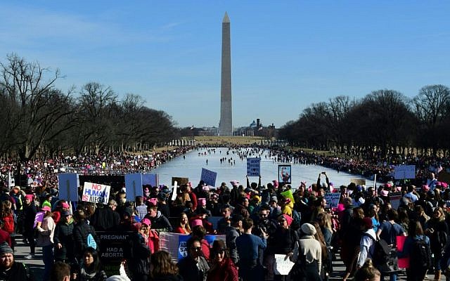People display signs as thousands take part in the Women's March on Washington 2018: March On The Polls! on the National Mall January 20, 2018 in Washington, DC. Getty Images