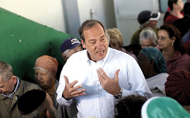 Rabbi Yechiel Eckstein at a Passover food distribution site in Lod, Israel, as part of his work with the International Fellowship of Christians and Jews. IFCJ